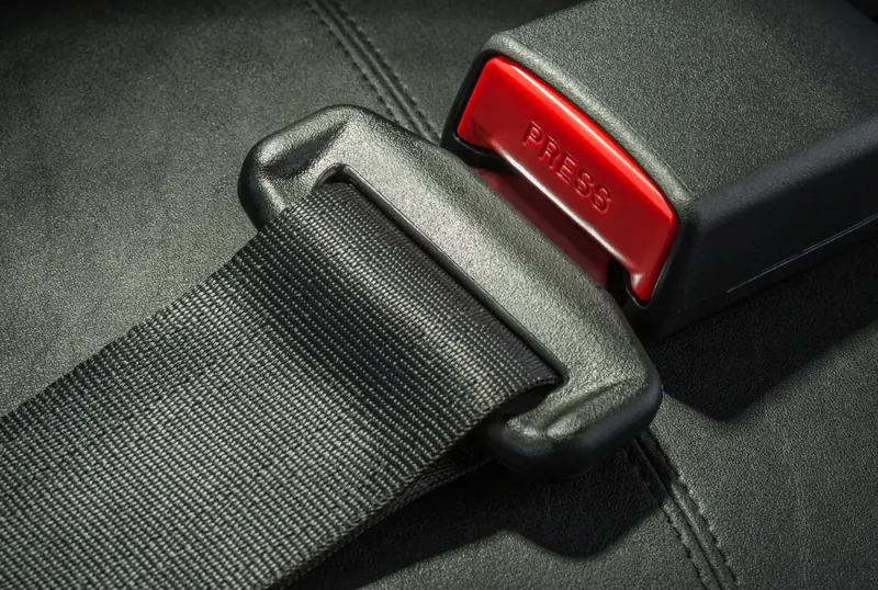 Seat belt webbing, latch plate and buckle receiver close up