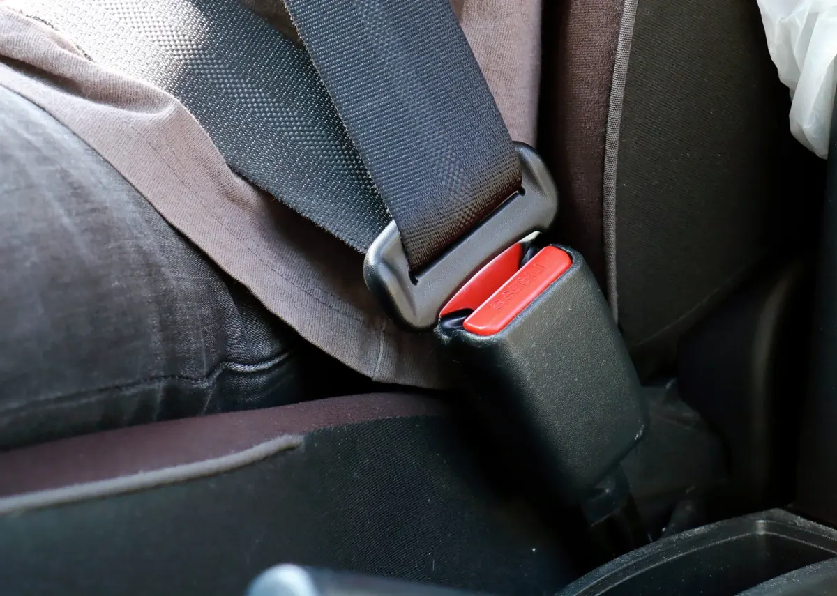 Fastened seat belt across a vehicle seat with the buckle engaged