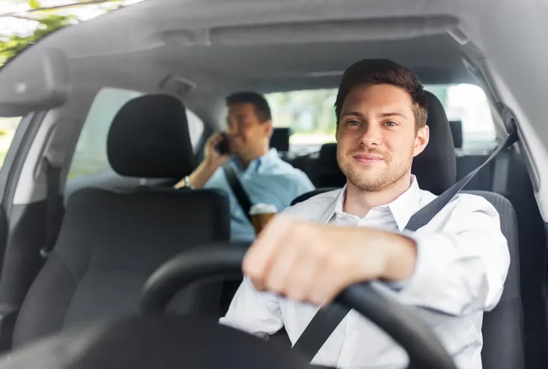 Driver and passenger travelling with seat belts fastened
