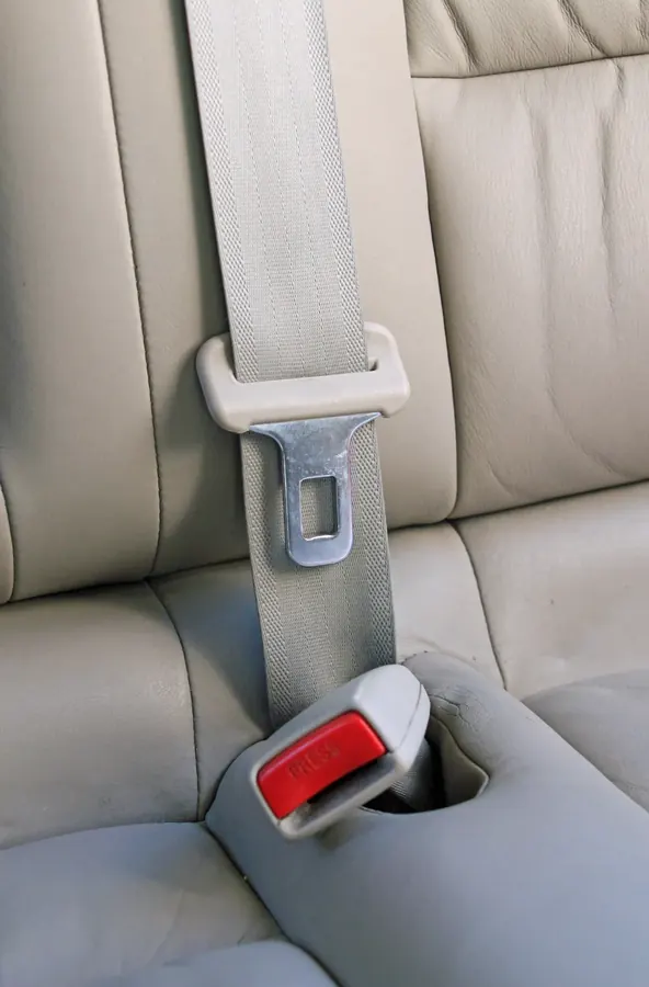 Three-point seat belt fitted to a vehicle seat with lap and diagonal sections visible