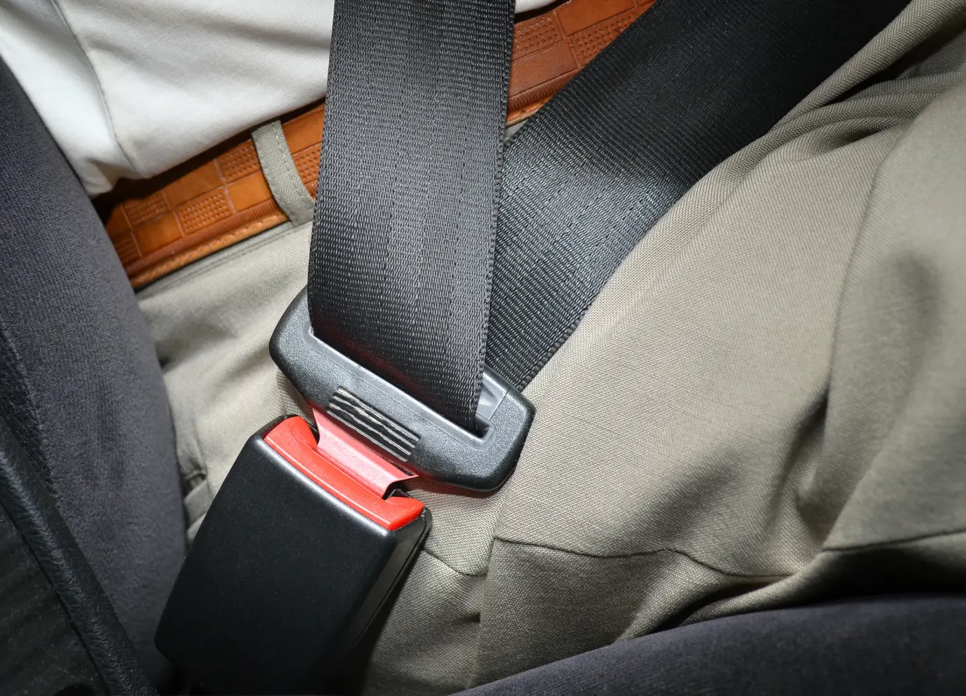 Fastened seat belt across an occupant seated in a vehicle