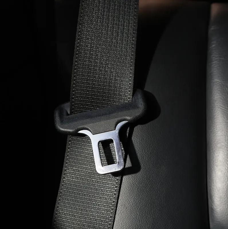 Seat belt webbing passing through a moulded shoulder guide